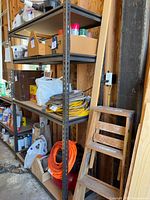 Full view of shelving unit loaded with items (items excluded)