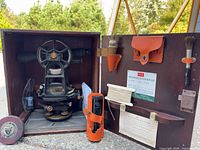 Transit in open wooden case with accessories and K&E label visible