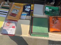 Top view of assorted office supplies including paper cutter, clipboards, pads, envelopes, folders