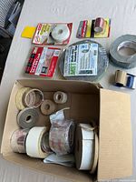 Overview of boxed tapes, packaged caulk strips, HVAC tape and applicator