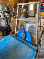Overall lot showing wood stepstool, heater, dustpan, brush and tarps