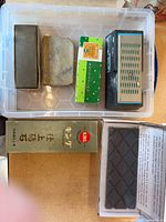 All six sharpening pieces inside bin and boxes