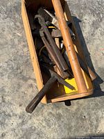 Toolbox top view showing multiple hammers and brush