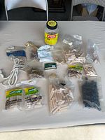 Overall view of all woodworking fasteners, jar and rope on table