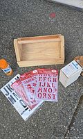 Lot overview showing wooden toolbox, spray paint, three stencil packs, Kreg Jig box