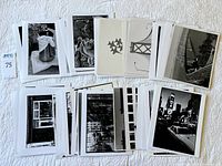 Spread of black and white 8x10 photographs laid on quilt showing variety of subjects