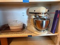 Overall lot showing mixer, bowl, attachments, dishes, manual