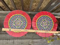 Pair of round mosaic tabletops with ruler for scale