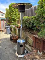 Full view of Nexgrill stainless steel patio heater standing on patio