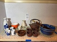 Group shot of all dinnerware items on shelf
