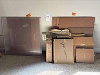 Stack of acrylic and glass sheets leaning against wall