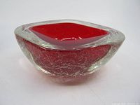Side view showing red interior and clear crackle exterior of bowl