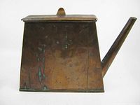 Full view of one side showing patina and spout