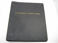 Closed album showing black cover with gold title