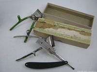 Overall lot showing two clippers, Durham razor, and box
