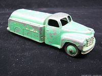 Left front view of green diecast tanker showing overall form and paint wear