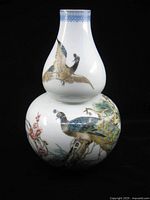 Full view of double-gourd vase with peacock and foliage decoration