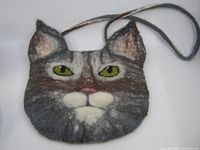 Front view of felted wool cat face purse with strap visible