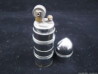 Kaschie bullet lighter with cap removed showing wick and striker wheel