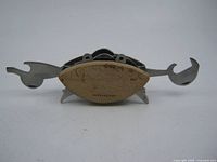 Front view of crab-shaped multi tool with tools extended
