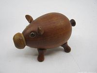 profile view showing teak pig shaker body, legs, tail