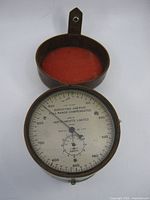 Full view of altimeter in open leather case
