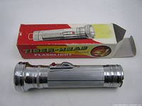 Flashlight beside box, full view
