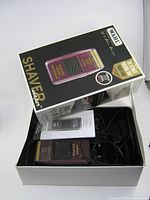 Box with shaver, manual and accessories visible