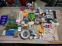 Overview of large assortment of arts and crafts materials spread on cutting mat