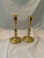 Front view of both brass candlestick holders