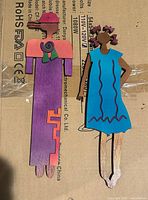 Front view of both painted metal wall figures showing colors and design details