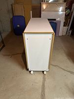 Table folded into narrow console form on casters