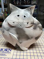 Front view of rounded ceramic cat sculpture