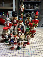 Group view of 19 assorted wooden nutcracker figurines