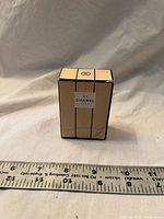 Front view of sealed Chanel N°5 perfume box next to ruler showing ~2 in height