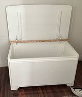 Chest open showing interior and yardstick for scale