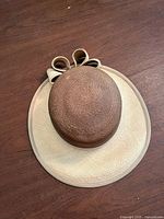 Top view of two-tone straw Panama hat, showing crown, brim and bow