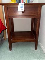 Front view of Ethan Allen nightstand showing drawer and shelf