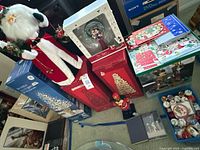 Full lot overview including GE tree box, cone tree boxes, Disney displays, Santa figure, ornaments bin and cards