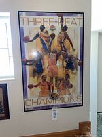 Framed Lakers Three-Peat Champions poster hung on wall