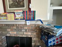 Mantle with multiple DVD sets, Friends collection, Nintendo Power Pad box and mat