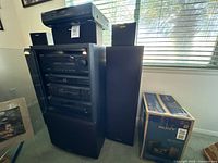 Front view of full component stack, tower speakers, satellite speaker, boxed CMT-BX5BT