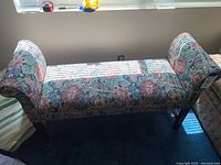 Full bench front view showing upholstery pattern and rolled arms