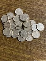 Pile of circulated 1967 Canadian quarters