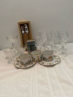 Group view of all items including cups, saucers, goblets, sherbets, mug, boxed utensils