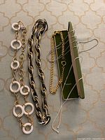 Overview of all five necklaces on fabric background