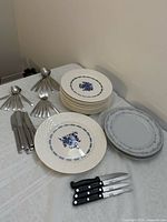 Overview of plates, flatware groups displayed on table