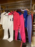 Entire lot hung on rack showing all seven clothing items