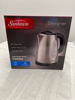 Front of retail box showing Sunbeam Designer Series stainless steel kettle and key specs