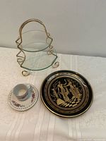 All items: cups on saucer, glass tiered server, black Greek design plate